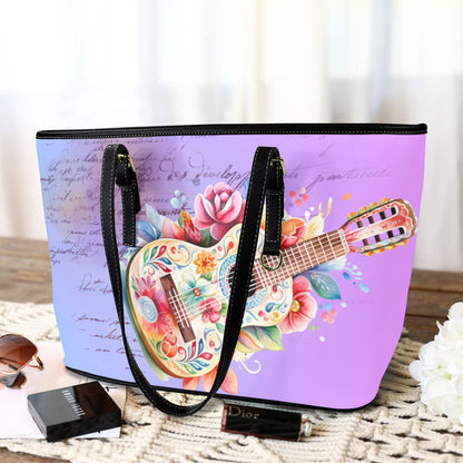 Purple tote bag with floral and guitar design on a wooden surface